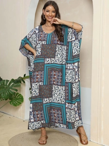 Close-up of bohemian print kaftan dress with V-neckline and loose batwing sleeves