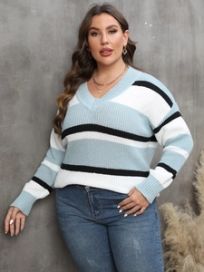Detail of plus size V-neck knit sweater featuring blue, white, and black color-block stripes