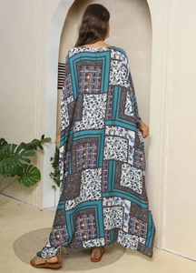 Detailed back view of a full-length printed ethnic kaftan dress with blue floral patterns