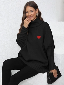 Close-up of red heart embroidery on black turtleneck knit sweater with ribbed collar