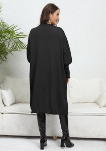 Rear view of women's oversized black knitted cardigan with dropped shoulders and ribbed cuffs
