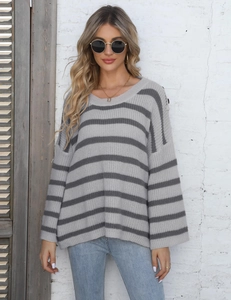 Macro detail of the gray striped knit fabric texture and high-quality button decoration