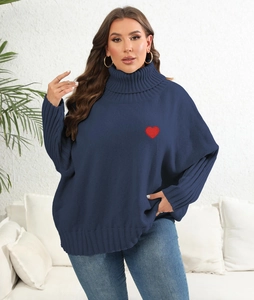Detailed view of the red heart embroidery on this navy blue oversized turtleneck sweater