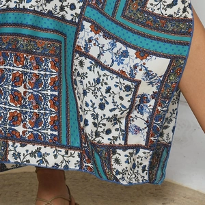 Close-up of bohemian floral patchwork print on lightweight ethnic style beach dress