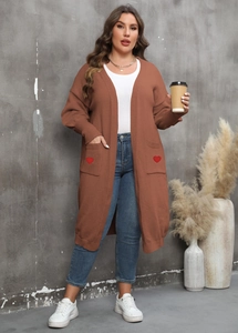 Detail of long brown cardigan featuring red heart embroidery patches on side pockets