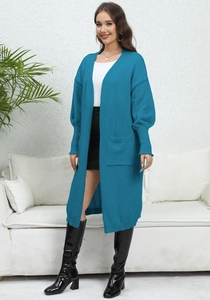 Deep peacock blue long knit cardigan featuring large side pockets and a stylish relaxed fit