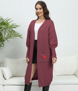 Detail of burgundy oversized cardigan featuring large front pockets and heart patch decoration