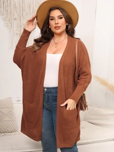 Detailed close-up showing the dark brown knit fabric texture and side pocket of the cardigan