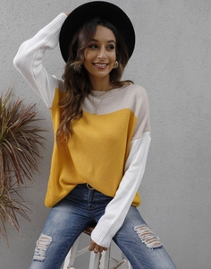 Detail of color block knit sweater showing yellow and grey panels with ribbed cuffs