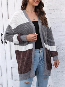 Detailed knit texture of a color-block cardigan with white, grey, and brown patchwork