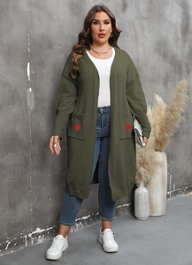 Detail of olive green knit cardigan featuring red heart patches on two front pockets