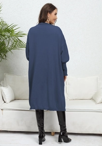 Detail of loose fit knit cardigan featuring puff lantern sleeves and ribbed cuffs