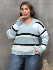 Detail of ribbed V-neckline and striped knit texture on a cozy oversized women sweater