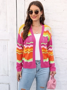 Close-up of rainbow striped knit cardigan with vibrant hollow crochet wavy pattern