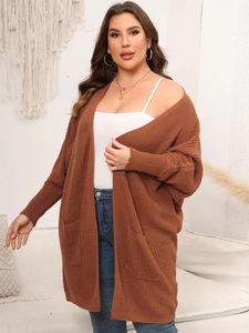 Close-up of caramel brown oversized cardigan featuring thick knit texture and large pockets