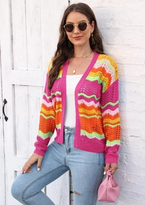Detail of colorful rainbow wavy crochet knit texture on a long-sleeved cardigan