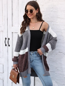 Close-up of color-block knit cardigan with grey, white and tan panels on model