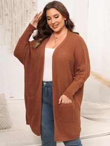 Detailed texture of brown chunky knit cardigan with large side pockets and relaxed fit