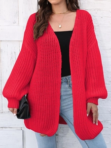 Detail of red oversized chunky knit cardigan showing thick texture and relaxed fit