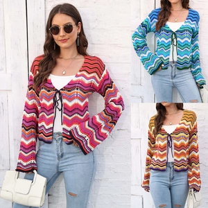 Detail of bohemian wavy striped knit cardigan with front tie closure and long sleeves
