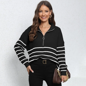 Detail view of women striped knit sweater with half-zip collar and thick texture