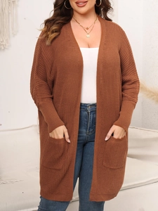 Detail of dark brown waffle knit cardigan featuring large side pockets and ribbed cuffs