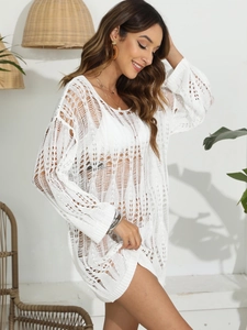 Close-up of white crochet knit beach cover-up featuring intricate hollow geometric patterns