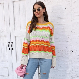 Detailed close-up of rainbow crochet knit texture and wavy striped pattern on the sweater