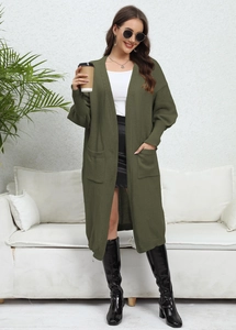 Detail of loose olive green long knit cardigan with large side pockets and ribbed sleeves
