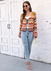 Detail of colorful rainbow wavy crochet cardigan with purple drawstring tie closure
