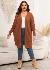 Detail of caramel knit cardigan featuring oversized front pockets and batwing sleeves
