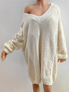 Women's beige loose knit sweater dress with deep V-neck and chunky cable stitch patterns