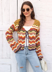 Detail of bohemian rainbow chevron knit cardigan with long sleeves and front tie closure