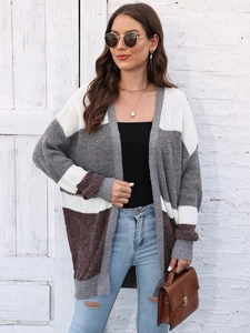 Outdoor shot of a casual oversized color-block knit cardigan with grey and brown panels