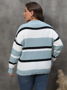 Detail view of oversized color block striped knit sweater in light blue, white and black
