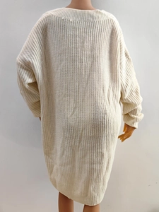 Detail of cream oversized knitted sweater showing thick knit texture on the back