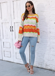 Close-up of vibrant rainbow wavy stripe knitwear with intricate crochet texture details