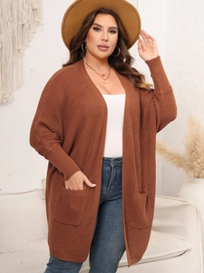 Detailed texture of brown knit cardigan featuring large side pockets and ribbed cuffs
