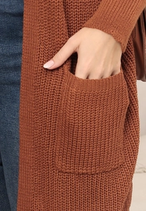 Detail of caramel oversized knit cardigan showing large side pocket and waffle texture