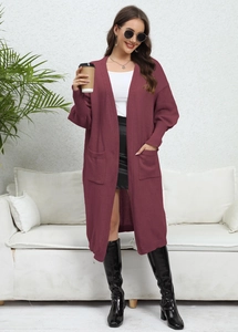Close-up of deep wine red knitted cardigan with ribbed cuffs and large front pockets