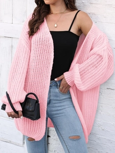 Detail of pink chunky knit cardigan showing soft mesh texture and drop shoulder design