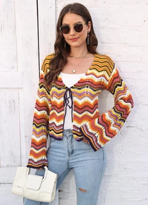 Close-up of rainbow stripe knitted cardigan featuring wavy patterns and tie-front closure