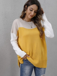 Detail view of contrast knit sweater with yellow and white panels and side split hem