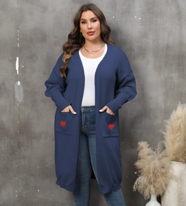 Detail of red heart embroidery on the deep blue cardigan large front pockets