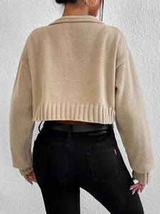 Back view of light khaki cropped knit cardigan with ribbed cuffs and collar detailing