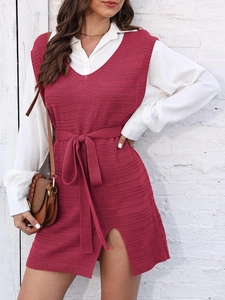 Women's burgundy knit vest dress with V-neck and waist tie over a white shirt