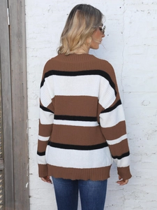 Detail of loose-fit striped knit sweater in brown, white and black colors for winter