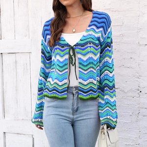 Close-up of zigzag crochet texture and tie-front detail on rainbow striped cardigan