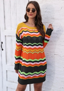 Close-up of colorful wavy crochet knit pattern on women's striped sweater dress