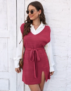 Detail of V-neck knitted sweater vest dress featuring a side slit and waist tie detail